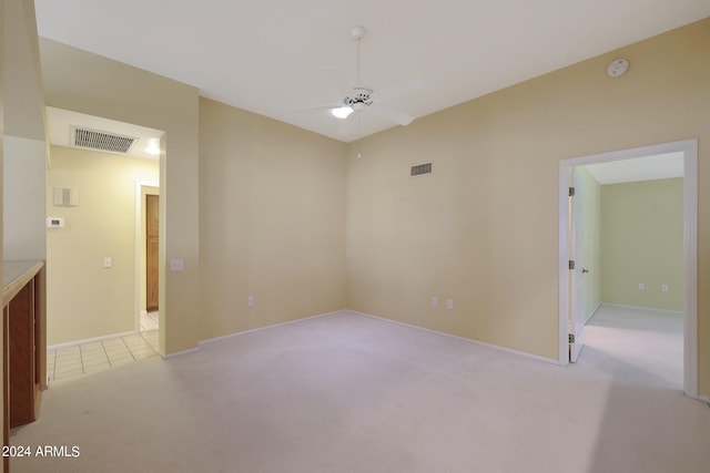 carpeted spare room with ceiling fan