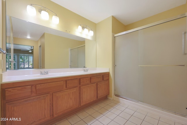 bathroom featuring vanity, ceiling fan, a shower with shower door, and tile patterned floors