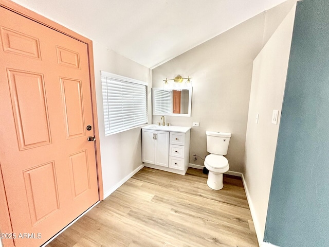 1705 E 6th St, Douglas, AZ 85607 - bathroom with wood finished floors, vaulted ceiling, baseboards, vanity, and toilet