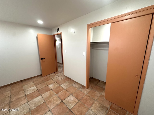 1705 E 6th St, Douglas, AZ 85607 - unfurnished bedroom featuring light stone finish flooring, recessed lighting, and a closet
