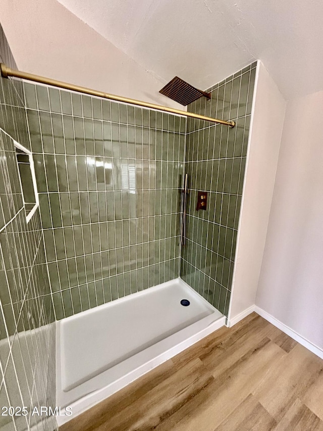 1705 E 6th St, Douglas, AZ 85607 - bathroom with tiled shower, wood finished floors, and baseboards
