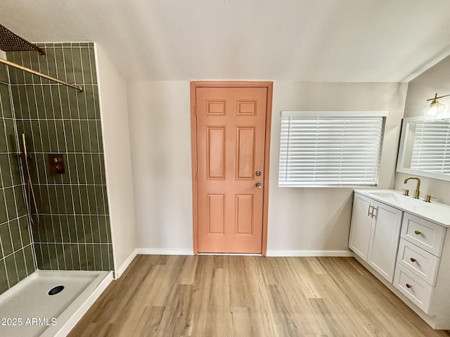 1705 E 6th St, Douglas, AZ 85607 - bathroom with wood finished floors, tiled shower, vanity, and baseboards