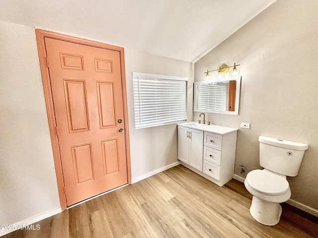 1705 E 6th St, Douglas, AZ 85607 - bathroom featuring vaulted ceiling, wood finished floors, toilet, baseboards, and vanity