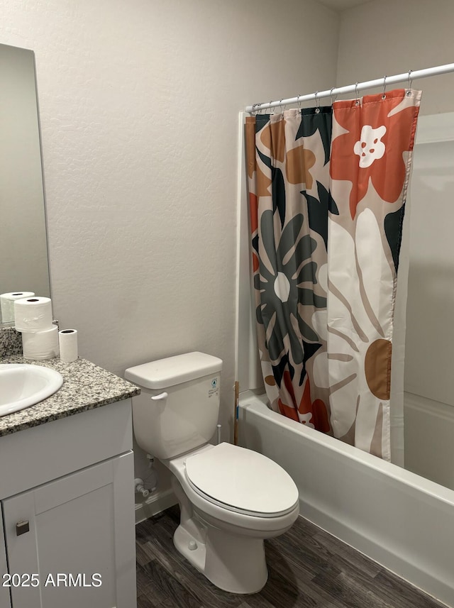 full bathroom featuring wood-type flooring, vanity, toilet, and shower / bath combo with shower curtain