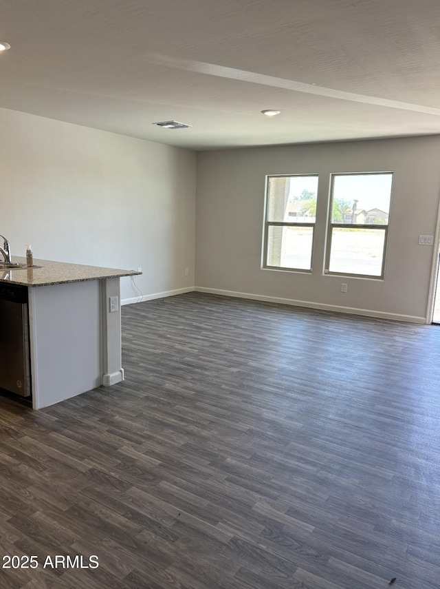 unfurnished living room with dark wood-type flooring and sink