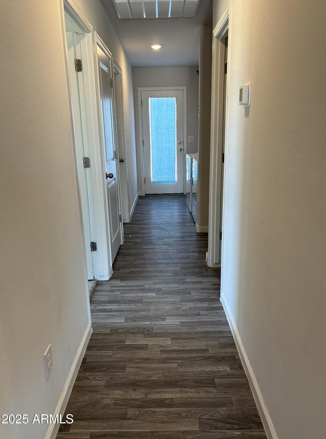 corridor with dark hardwood / wood-style flooring