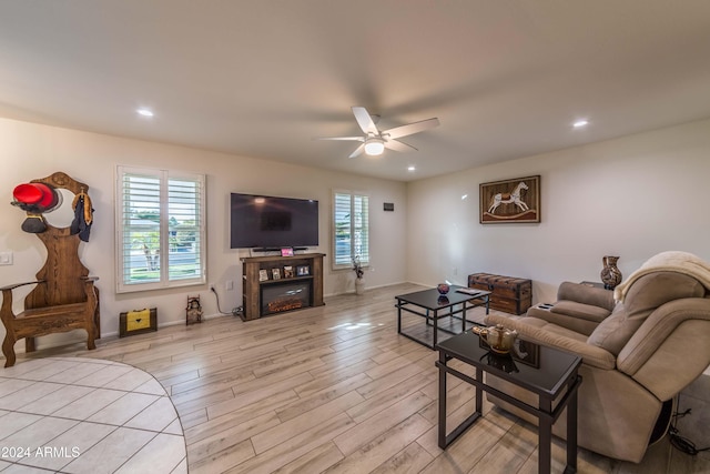 living room with ceiling fan and light wood-type flooring