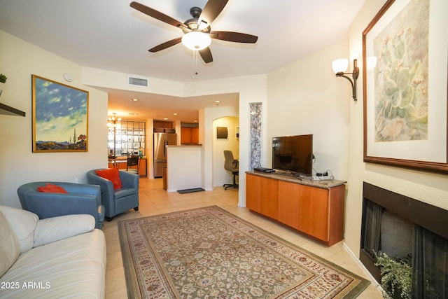 tiled living room featuring ceiling fan