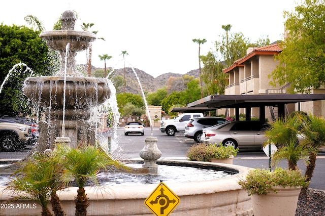 view of vehicle parking featuring a mountain view