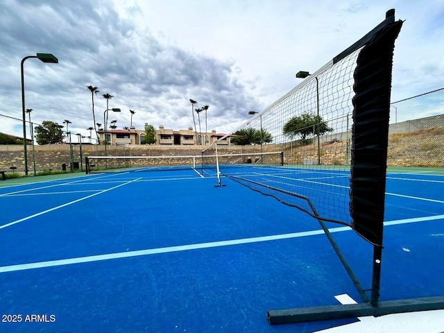 view of tennis court featuring basketball court