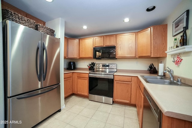 kitchen with sink, appliances with stainless steel finishes, and light tile patterned flooring