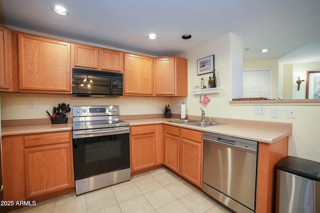 kitchen featuring sink, stainless steel appliances, and light tile patterned flooring