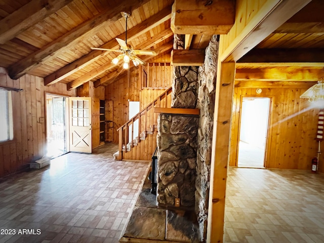 interior space featuring wood walls, wood ceiling, and a healthy amount of sunlight