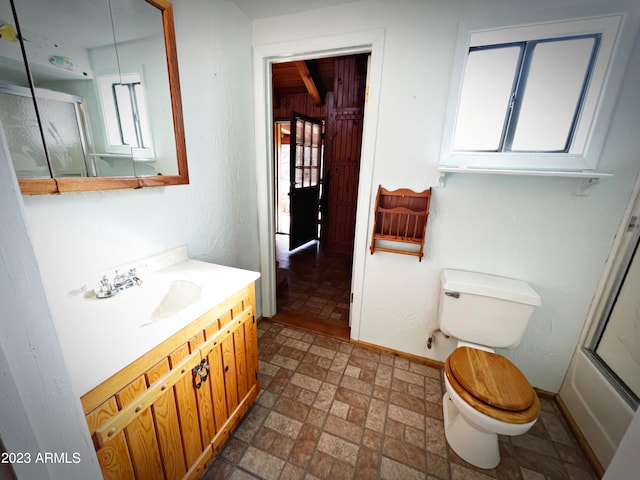 bathroom featuring tile flooring, toilet, and vanity