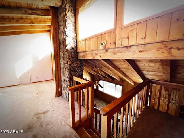 stairs with carpet, wooden ceiling, and vaulted ceiling with beams