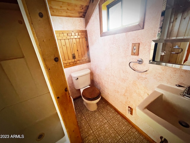 bathroom featuring tile floors, toilet, and sink