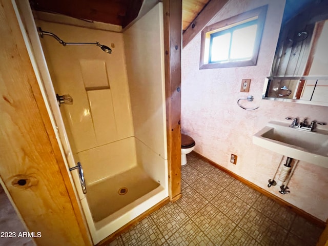 bathroom with sink, walk in shower, tile flooring, and toilet