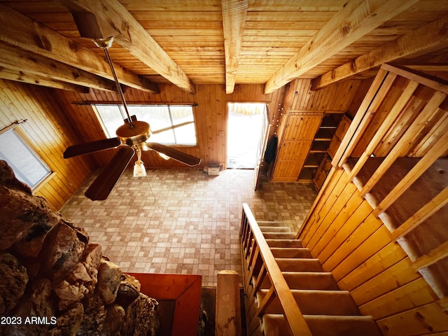 interior space with ceiling fan, beamed ceiling, and wood ceiling