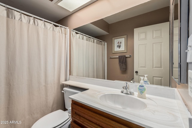 full bath with toilet and vanity
