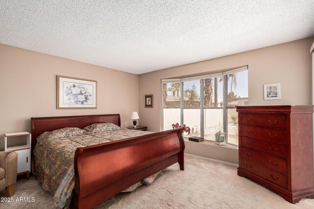 bedroom featuring light colored carpet, baseboards, and a textured ceiling