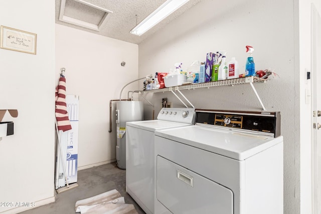 laundry area featuring water heater, separate washer and dryer, laundry area, and a textured ceiling