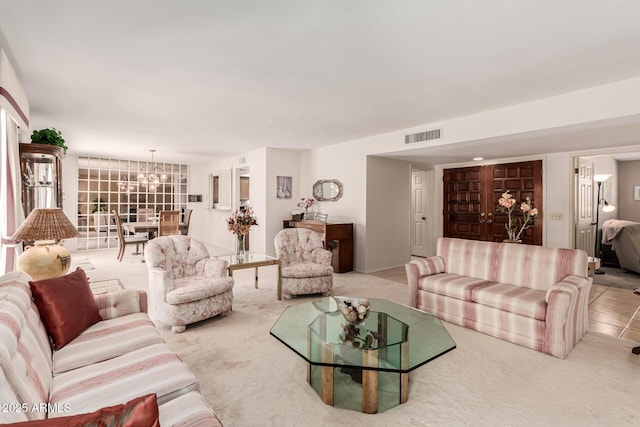 living room with carpet floors, a chandelier, and visible vents