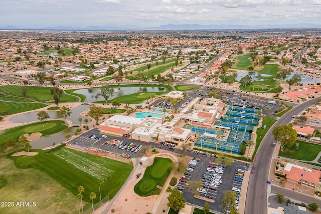 aerial view with golf course view and a water view