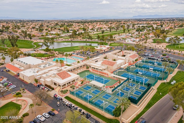 birds eye view of property with a water view and view of golf course