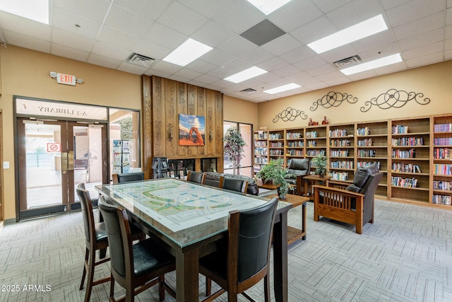 dining area with a paneled ceiling and visible vents