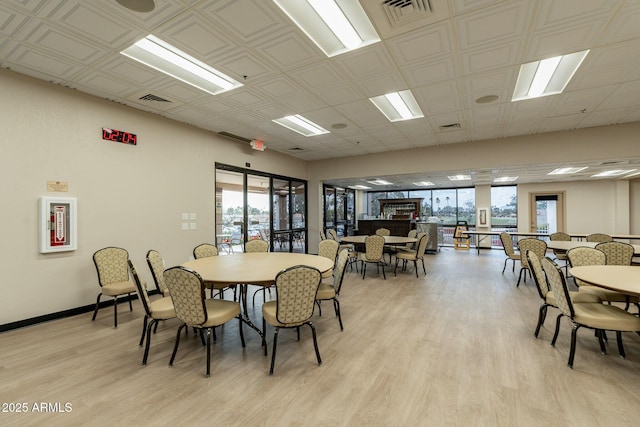 dining room featuring visible vents, baseboards, and light wood-type flooring