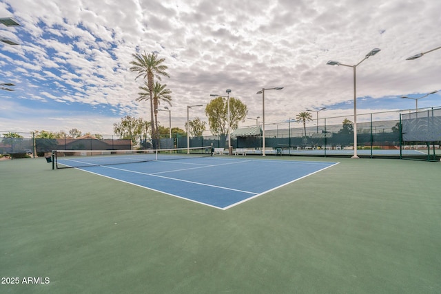 view of tennis court with fence