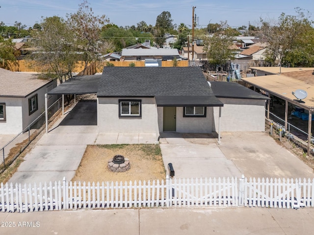 826 S Drew St, Mesa, AZ 85210 - view of front of property with a fenced front yard, roof with shingles, an outdoor fire pit, stucco siding, and concrete driveway