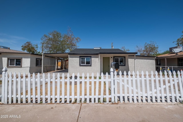 826 S Drew St, Mesa, AZ 85210 - view of front of property with stucco siding, a fenced front yard, a carport, and driveway