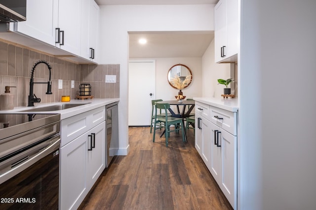 826 S Drew St, Mesa, AZ 85210 - kitchen with light countertops, dark wood-style flooring, stainless steel appliances, and tasteful backsplash