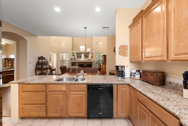 kitchen featuring visible vents, dishwasher, a peninsula, arched walkways, and a sink