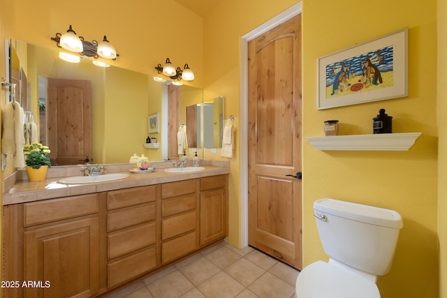 full bath with tile patterned flooring, double vanity, toilet, and a sink