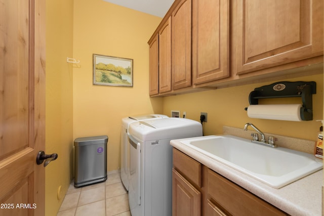 laundry area with washer and clothes dryer, cabinet space, light tile patterned flooring, and a sink