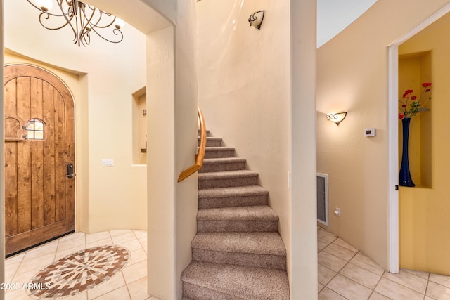 tiled entryway with stairway and arched walkways