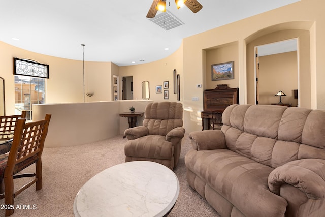 carpeted living area with visible vents, recessed lighting, and a ceiling fan