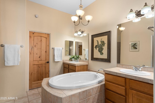 bathroom featuring tile patterned flooring, two vanities, a garden tub, and a sink