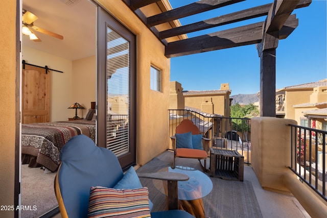 balcony featuring a mountain view and a pergola