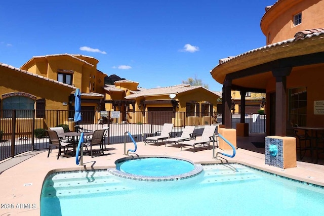 pool featuring a patio and fence