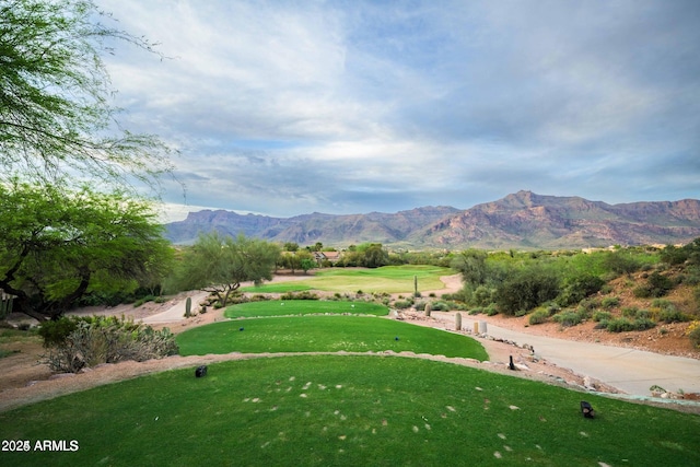 view of community with a lawn and a mountain view