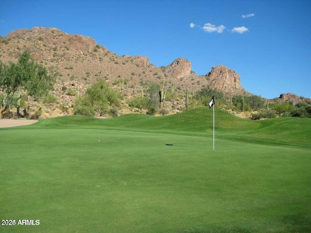 view of home's community featuring a yard, a mountain view, and golf course view