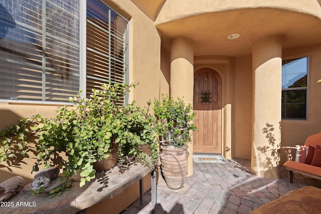 view of exterior entry with stucco siding