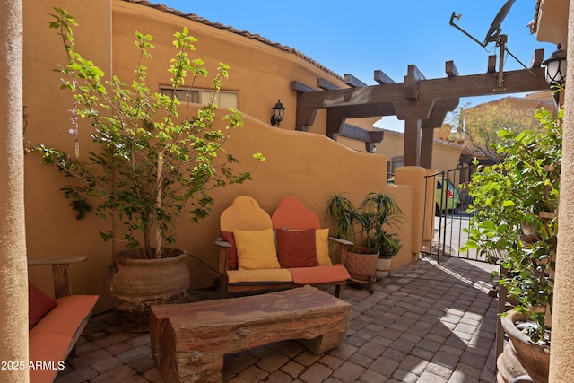 view of patio with an outdoor living space, a gate, and fence