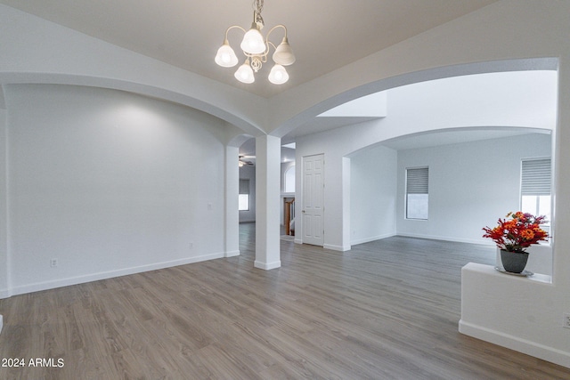 interior space featuring hardwood / wood-style flooring and an inviting chandelier