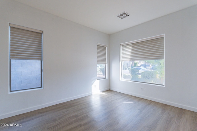 spare room with hardwood / wood-style floors