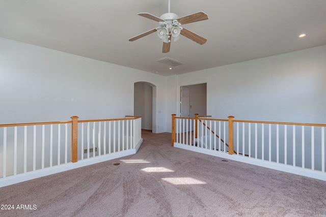 unfurnished room featuring ceiling fan and light carpet