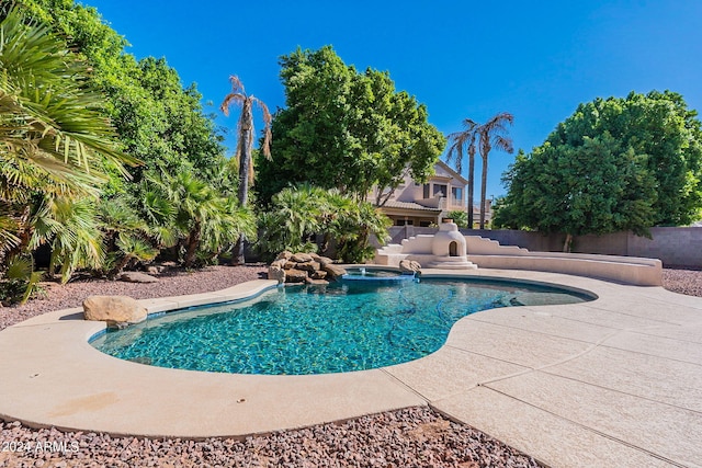 view of swimming pool featuring an in ground hot tub and a patio area